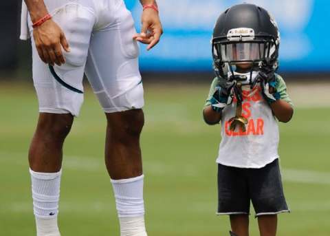 Child wearing football helmet