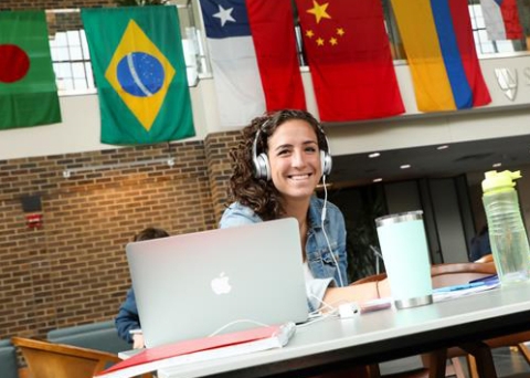Student studying with flags behind